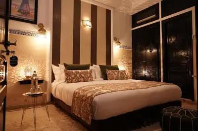 a bedroom with a large bed in a room at Riad Roummana Marrakech in Marrakech