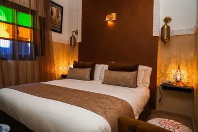 a bedroom with a large bed in a hotel room at Riad Roummana Marrakech in Marrakech