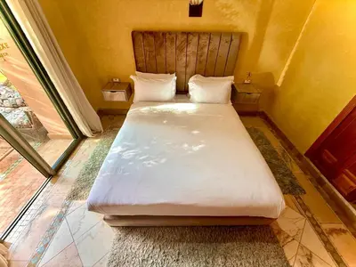 a bedroom with a large white bed in a room at Les Jardins de la palmeraie in Marrakech