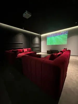 a living room with couches and a large screen television at magnifique villa golf amelkis sans vis-à-vis in Marrakech