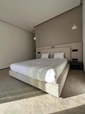 a bedroom with a large bed with white sheets at magnifique villa golf amelkis sans vis-à-vis in Marrakech