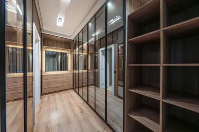 a walk in closet with wooden shelves at Villa Tolède by TheCasaEdition in Marrakech