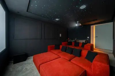 a living room with a red couch and a window at Villa Tolède by TheCasaEdition in Marrakech