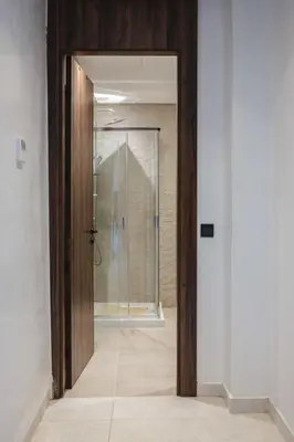 a bathroom with a shower and a glass door at Appartement Uniquement Familial 2 Chambres spacieux cosy, calme in Marrakech
