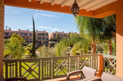 a balcony with chairs and a view of a city at Tibouda House Deluxe Avec Piscine - Familiale in Marrakech