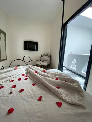 a bedroom with red hearts on the bed at Riad Ayiss piscine palmeraie in Marrakech