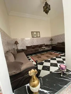 a living room with a bed and a checkered floor at Riad Ayiss piscine palmeraie in Marrakech