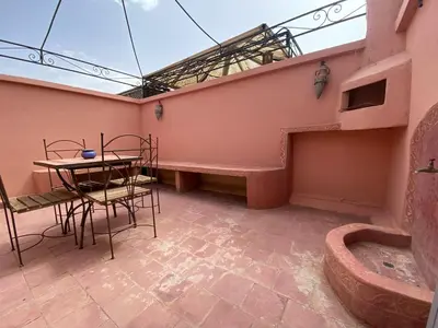 a room with a table and a table and chairs at Riad Ayiss piscine palmeraie in Marrakech