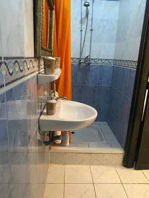 a bathroom with a sink and a shower at Riad Ayiss piscine palmeraie in Marrakech
