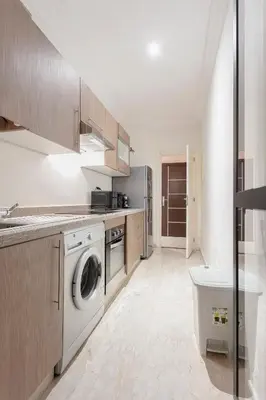 a kitchen with a washing machine and a washer at The Vogue – Marrakech Centre in Marrakech