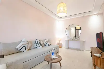 a living room with a couch and a table at The Vogue – Marrakech Centre in Marrakech
