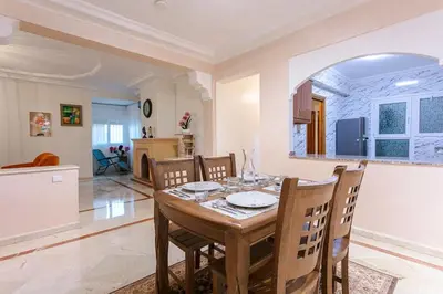 a dining room and kitchen with a table and chairs at Modern Odyssey – Marrakech Centre in Marrakech