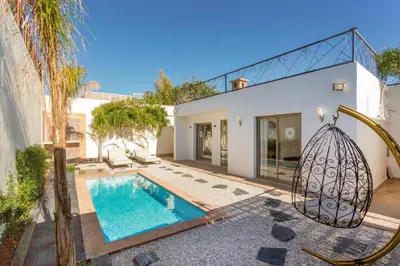 a swimming pool in the backyard of a house at Villa privée avec piscine Sans vis-à-vis, calme absolu in Marrakech
