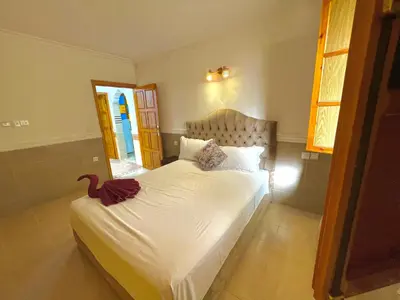 a bedroom with a bed with a red duck on it at Villa privée avec piscine Sans vis-à-vis, calme absolu in Marrakech