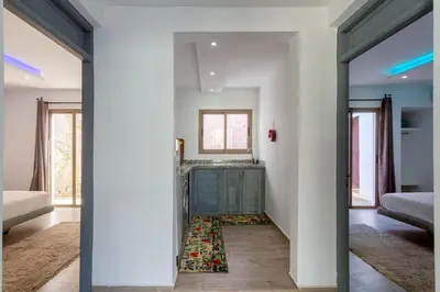 a bedroom with a green dresser and a mirror at Villa privée avec piscine Sans vis-à-vis, calme absolu in Marrakech