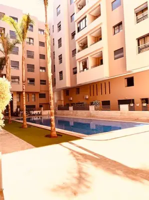 a hotel with a swimming pool in front of a building at Menara Garden pool in Marrakech