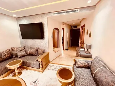 a living room with a couch and a flat screen tv at Menara Garden pool in Marrakech