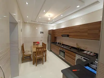 a kitchen with a table and a dining room at Chez bousfyha in Marrakech