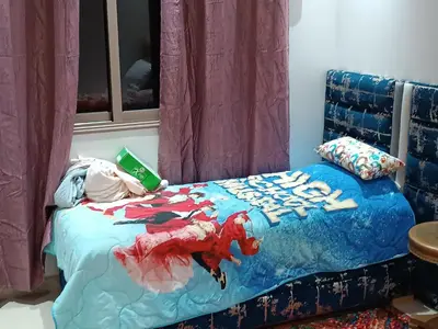 a bed with a comforter with a deadpool on it at Chez bousfyha in Marrakech