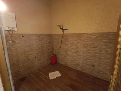 a room with a brick wall with a broom at Chez bousfyha in Marrakech