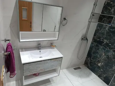 a bathroom with a sink and a mirror and a shower at Chez bousfyha in Marrakech