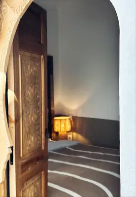 a hallway with a door and a lamp in a room at Riad de l'Ô with Pool, Rooftop, Free Breakfast in Marrakech