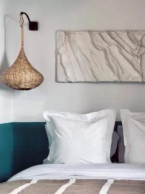 a bedroom with a bed with white pillows and a lamp at Riad de l'Ô with Pool, Rooftop, Free Breakfast in Marrakech