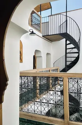 a staircase in a building with a spiral stair case at Riad de l'Ô with Pool, Rooftop, Free Breakfast in Marrakech