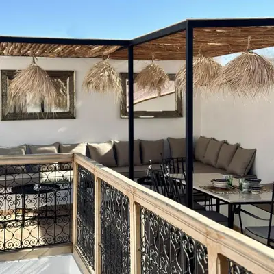 a balcony of a restaurant with a table and chairs at Riad de l'Ô with Pool, Rooftop, Free Breakfast in Marrakech