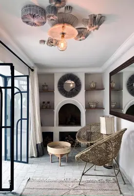 a living room with a table and a mirror at Riad de l'Ô with Pool, Rooftop, Free Breakfast in Marrakech