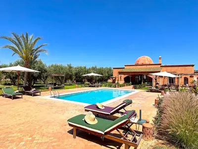 a house with a swimming pool and a building at Palais Sena in Marrakech
