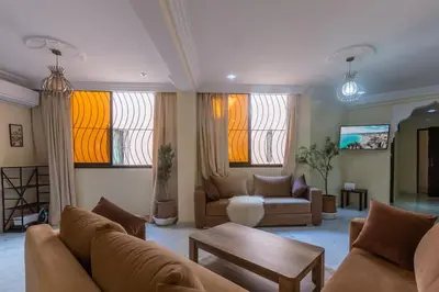 a living room with a couch and a table at Appartement Unique au Centre in Marrakech