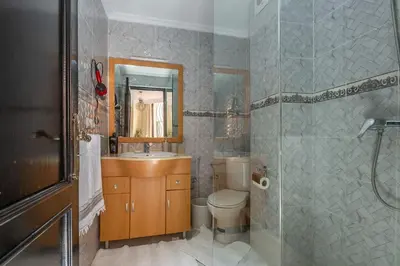 a bathroom with a sink and a toilet and a shower at Appartement Unique au Centre in Marrakech