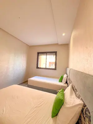 a bedroom with two beds and a window at Condo in marrakech with pool in Marrakech