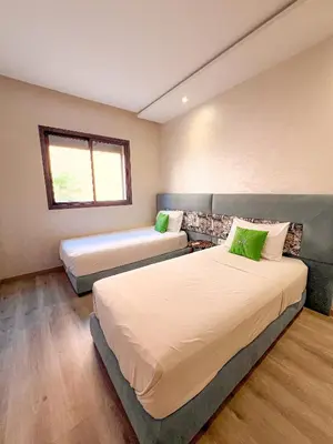 a bedroom with two beds and a window at Condo in marrakech with pool in Marrakech