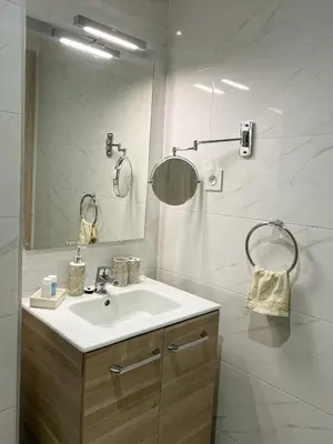 a bathroom with a sink and a mirror at Condo in marrakech with pool in Marrakech