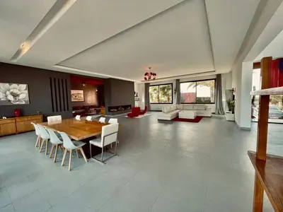 a large living room with a wooden table and chairs at Villa Dar El Hna in Marrakech
