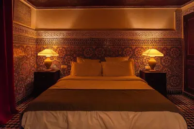 a bedroom with a large bed with two lamps at LUXURY apartment in Marrakech
