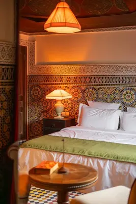 a bedroom with a bed and a table with a lamp at LUXURY apartment in Marrakech