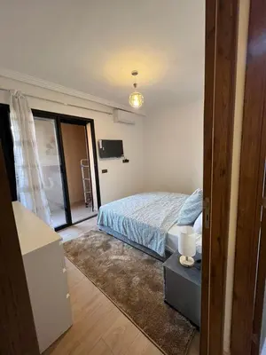 a bedroom with a bed and a television in it at Cozy apartment in city center in Marrakech