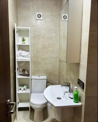 a bathroom with a white toilet and a sink at Cozy apartment in city center in Marrakech