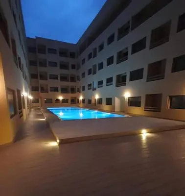a swimming pool in the middle of a building at Cozy apartment in city center in Marrakech