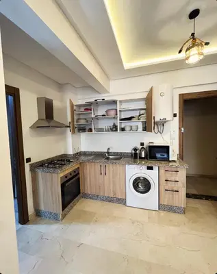 a kitchen with a washer and dryer at Cozy apartment in city center in Marrakech