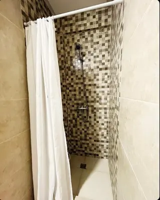 a bathroom with a shower with a shower curtain at Cozy apartment in city center in Marrakech