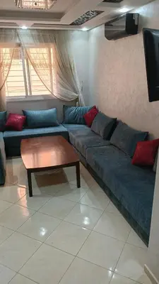 a living room with a blue couch and a table at Marrakech Chic and moderne appartement in Marrakech