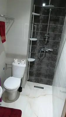 a bathroom with a toilet and a shower at Marrakech Chic and moderne appartement in Marrakech