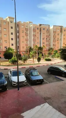 three cars parked in a parking lot in front of a building at Marrakech Chic and moderne appartement in Marrakech