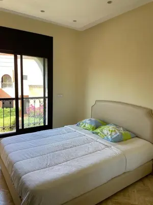 a large bed in a bedroom with a window at Strasmarrakech in Marrakech