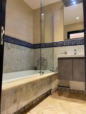 a large bathroom with a tub and a shower at Strasmarrakech in Marrakech