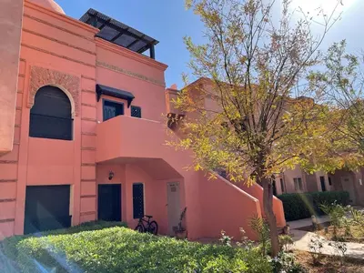 a pink building with a tree in front of it at Strasmarrakech in Marrakech